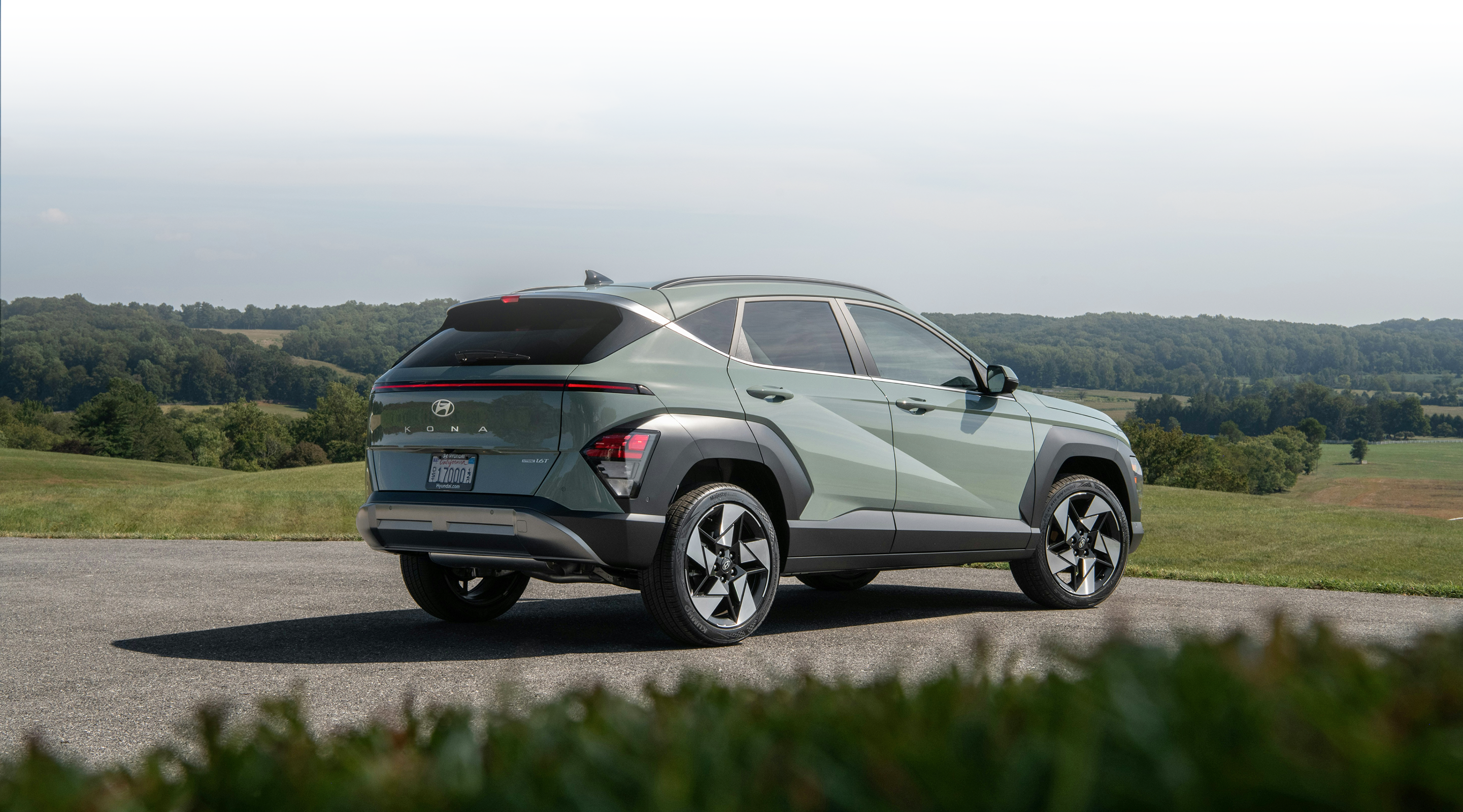 SUV parked with a hillside background